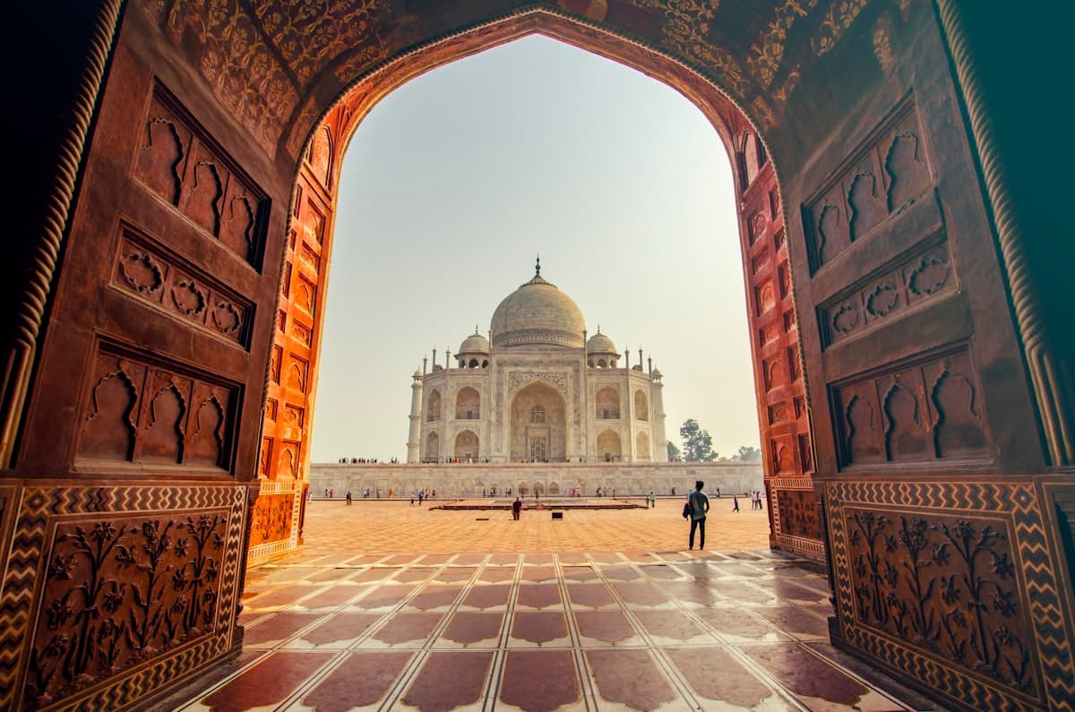 The Taj Mahal framed by a carved gateway
