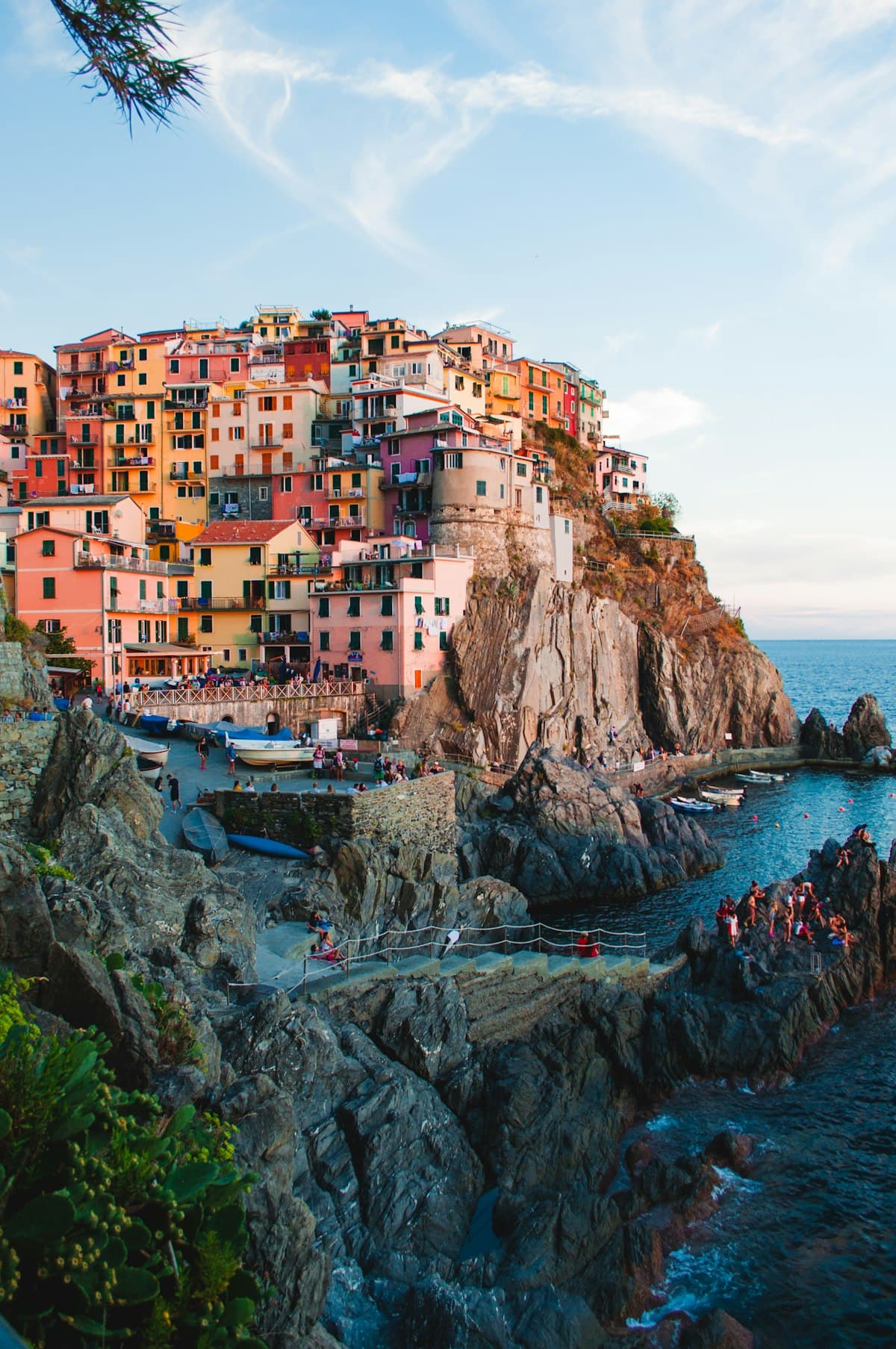 Coloured houses stacked above a harbour on the Ligurian coast