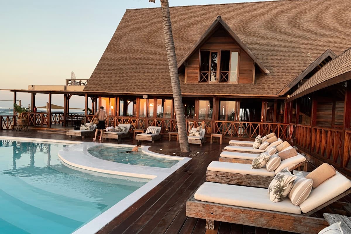 Loungers beside a resort pool at golden hour