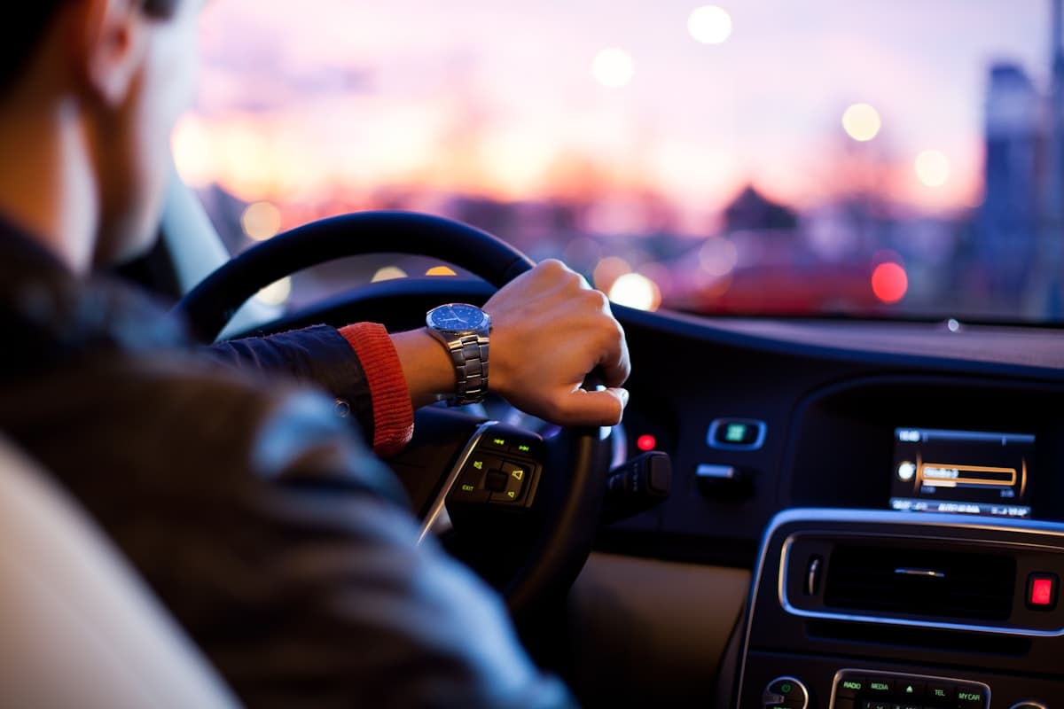 A driver on the road as the light fades